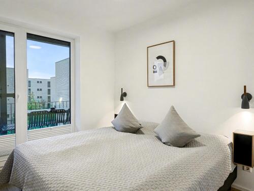a bedroom with a bed and a large window at Apartment Seezauber by Interhome in Lembruch