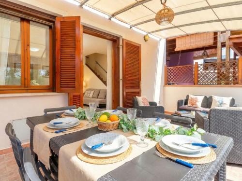 a dining room with a table and chairs at Apartment Rais 13 by Interhome in Stintino
