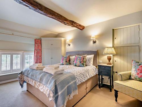 a bedroom with a large bed and a chair at 2 Bed in Bakewell oc-61862 in Baslow