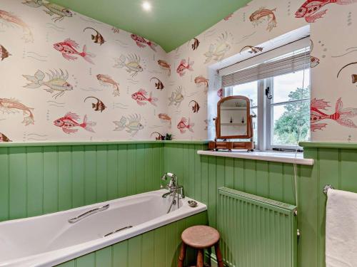 a green bathroom with a tub and a window at 2 Bed in Bakewell oc-61862 in Baslow