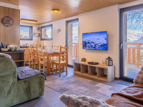 a living room with a table and a dining room at Chalet Byzance by Interhome in Nendaz
