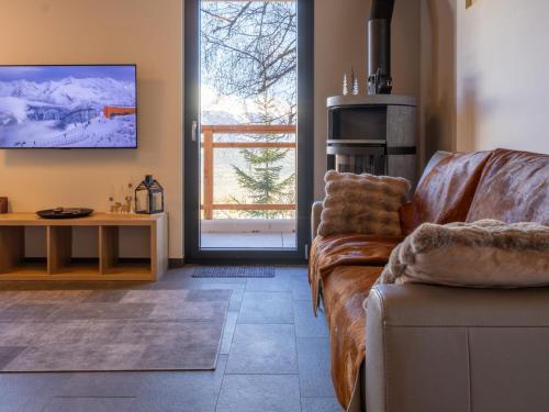 a living room with a couch and a table at Chalet Byzance by Interhome in Nendaz