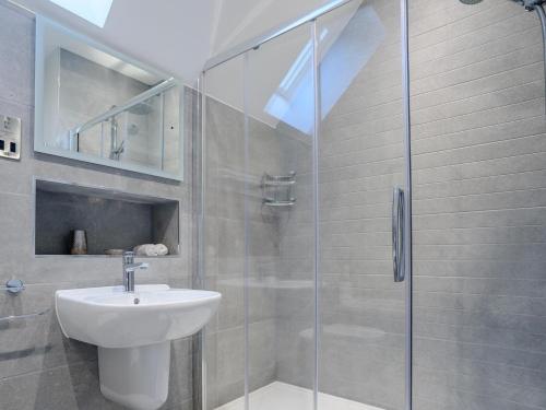 a bathroom with a sink and a glass shower at 2 Bed in Chipping Campden oc-78128 in Chipping Campden