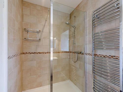 a shower with a glass door in a bathroom at 3 Bed in Eyam oc-pk835 in Eyam