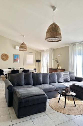 a living room with a blue couch and a table at Villa Tarabucetta by Interhome in Figari