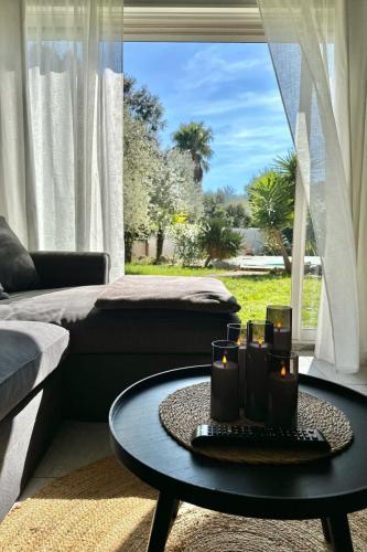 a living room with a table with candles on it at Villa Tarabucetta by Interhome in Figari