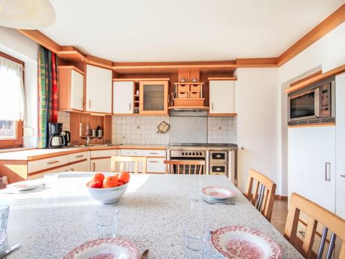 a kitchen with a table with a bowl of fruit on it at Chalet Schlitters by Interhome in Schlitters