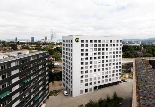 a white building with a logo on the side of it at B&B HOTEL Basel in Basel