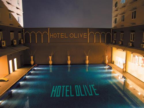 a large swimming pool in the middle of a building at Hotel Olive in Tangerang