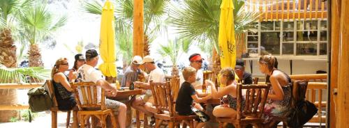 a group of people sitting in chairs at a restaurant at Pirate Cove Resort in Needles