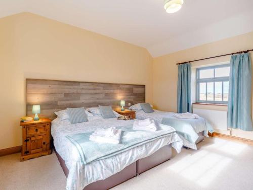 a bedroom with two beds and a window at 3 Bed in Consett oc-29403 in Lanchester