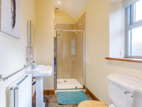 a bathroom with a shower and a sink and a toilet at 3 Bed in Consett oc-29403 in Lanchester