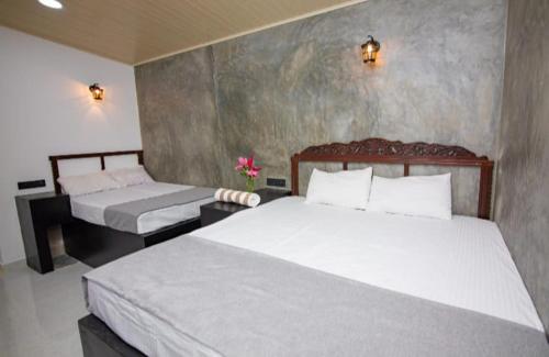 two beds in a room with two beds sidx sidx sidx sidx at City Villa Dikwella in Dickwella