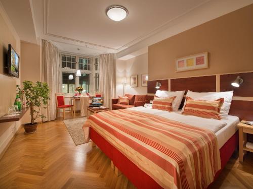 a bedroom with a bed and a living room at EA Hotel Julis in Prague
