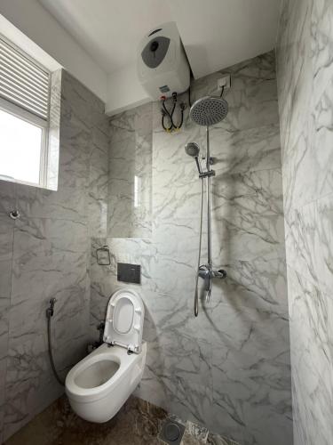 a bathroom with a toilet and a shower at Lucky Homes in Maharagama