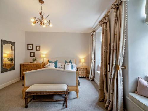 a bedroom with a bed and a chair and a mirror at 4 Bed in Middleham oc-g0189 in Middleham