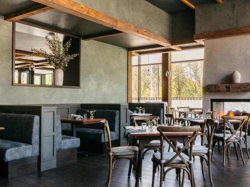 a restaurant with tables and chairs and a fireplace at The Study at the University of Chicago in Chicago