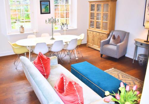 a living room with a couch and a table at West Pallant Georgian Townhouse in City Centre with Courtyards, BBQ & Log Burners - Dogs Welcome! Chichester Holiday Properties in Chichester