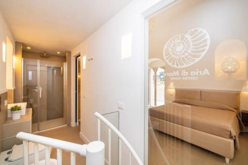 a small room with a bed and a staircase at Aria di Mare CENTER HOME in Vieste