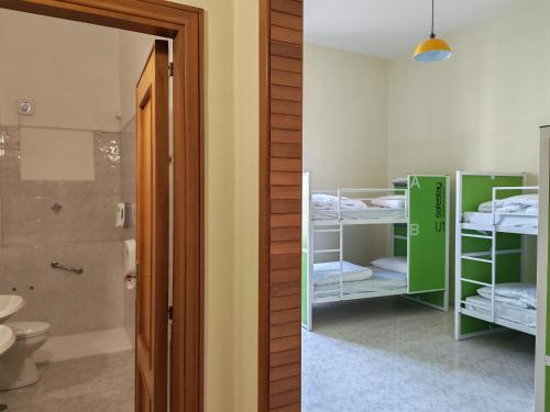 a room with a bathroom with bunk beds and a shower at Safestay Naples Materdei in Naples