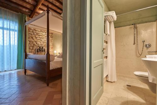 a bathroom with a bedroom with a bed and a shower at La Gazzara Castell'in Villa in Castelnuovo Berardenga