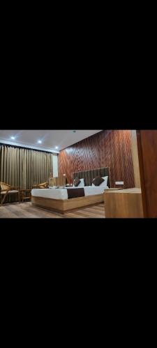a bedroom with a large bed in a room at Hotel GS GRAND in Dehradun