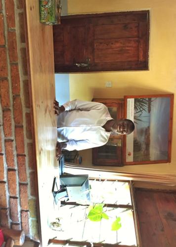 a man standing in front of a mirror at Outpost Lodge in Arusha