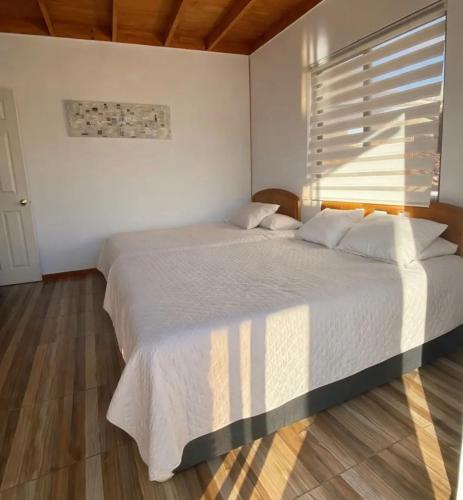 a bedroom with a large bed and a window at San José Hotel Boutique & Spa in La Ligua