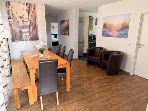 a dining room with a wooden table and chairs at Hilda Apartments Rust in Rust