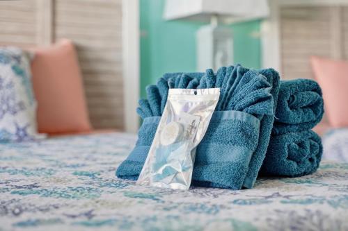 a blue towel on a bed with a pile of money at Blind Pass Resort Motel in St. Pete Beach