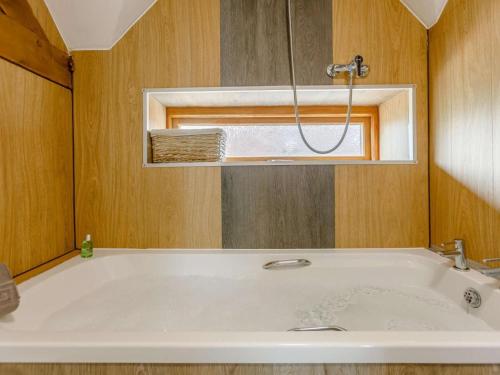 a bath tub in a bathroom with a shower at 2 Bed in Pershore oc-83007 in Eckington