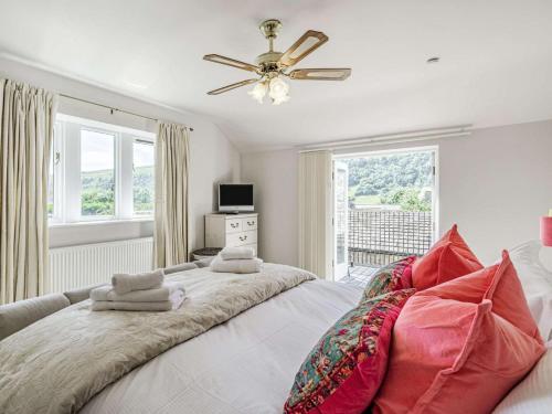 a bedroom with a large bed with a ceiling fan at 4 Bed in Skipton oc-89095 in Starbotton