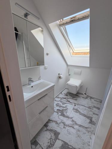 a bathroom with a sink and a mirror at Loft Apartment with Parking in Poruba
