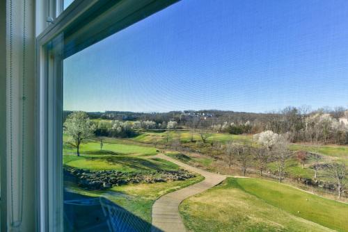 a window with a view of a golf course at Gorgeous Condos at Thousand Hills - Heart of Branson - Spacious and Affordable in Branson