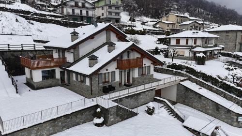 a house with snow on top of it at Ca' Piramidi Casa Vacanze in Postalesio