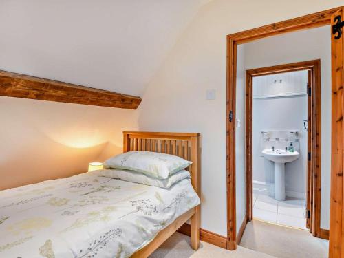 a bedroom with a bed and a sink at 2 Bed in Wareham oc-dc184 in Stoborough