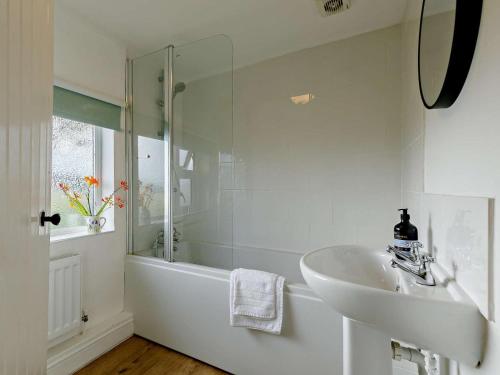 a white bathroom with a sink and a shower at 3 Bed in Pershore oc-92975 in Eckington