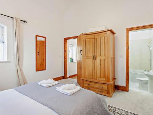 a bedroom with a bed and a cabinet and a sink at 2 Bed in Malmesbury oc-91453 in Malmesbury