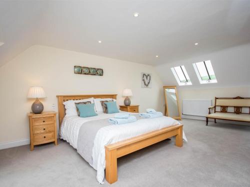 a bedroom with a large bed with blue pillows at 3 Bed in Wareham oc-dc137 in West Lulworth