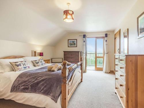 a bedroom with a bed and a dresser and a window at 4 Bed in Worcester oc-77991 in Clifton upon Teme