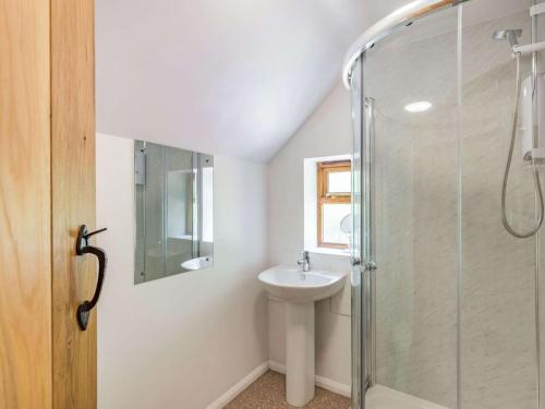 a bathroom with a sink and a glass shower at 4 Bed in Worcester oc-77991 in Clifton upon Teme