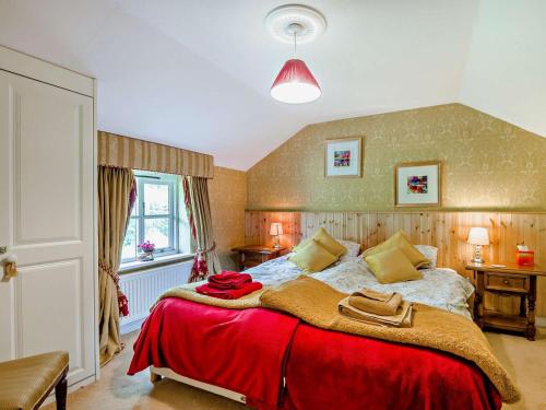 a bedroom with a large bed with a red blanket at 4 Bed in Lydney oc-55969 in Bream