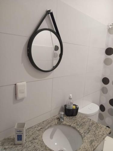 a bathroom with a sink and a mirror on the wall at Apto Candelária in Rio de Janeiro