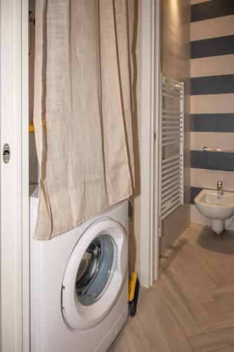 a washing machine in a bathroom with a sink at Ledy Apartment in Lovere