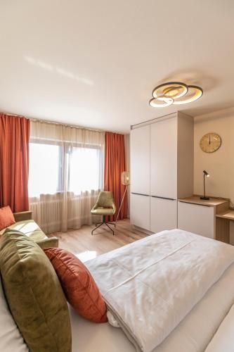 a bedroom with a large bed and a chair at Starzel Rooms in Alling