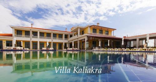 a building with a pool in front of it at Complex Villas Kaliakra & Gradina in Bŭlgarevo