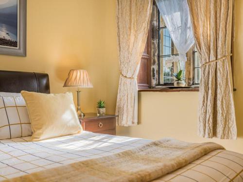 a bedroom with a bed and a window at 1 Bed in Penrith oc-sz350 in Orton
