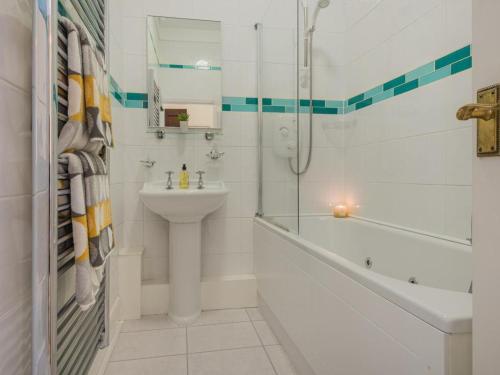 a bathroom with a sink and a shower and a toilet at 1 Bed in Penrith oc-sz350 in Orton