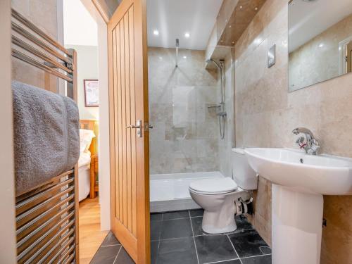 a bathroom with a sink and a toilet and a tub at 3 Bed in Hexham oc-96038 in Bardon Mill