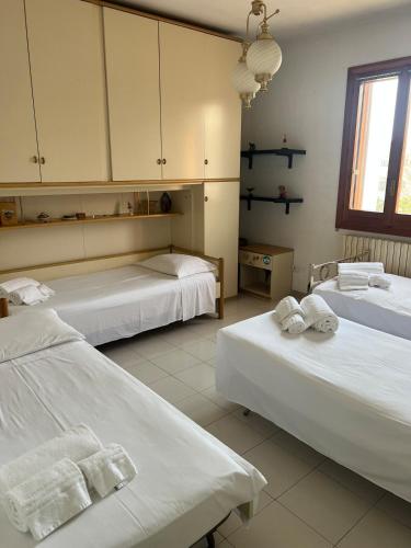 a room with two beds with towels on them at Dimora Maffi in Metaponto